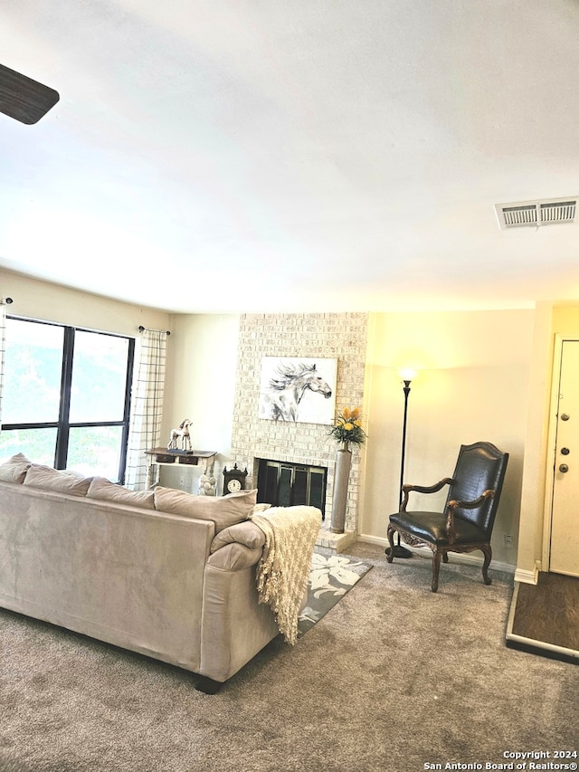 living room with a fireplace and carpet flooring