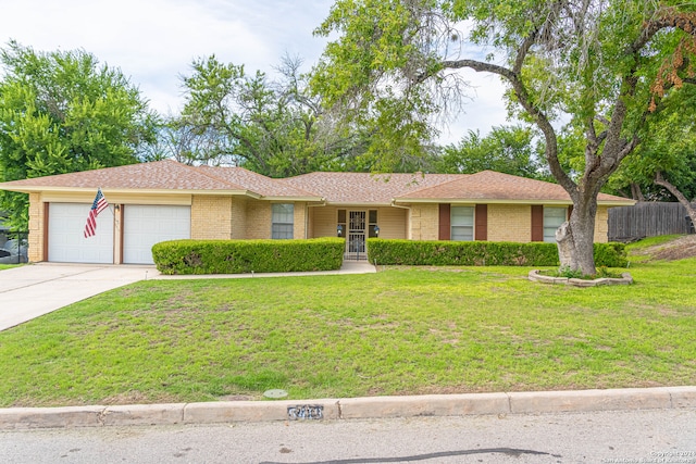 ranch-style house with a garage and a front yard