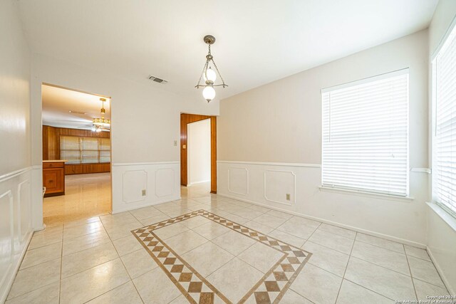 tiled spare room featuring ceiling fan