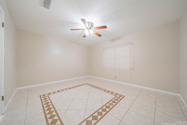 tiled spare room featuring ceiling fan