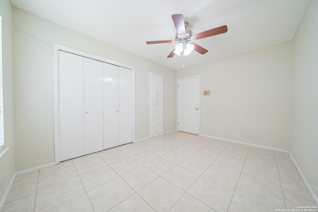 unfurnished bedroom featuring ceiling fan and light tile patterned floors