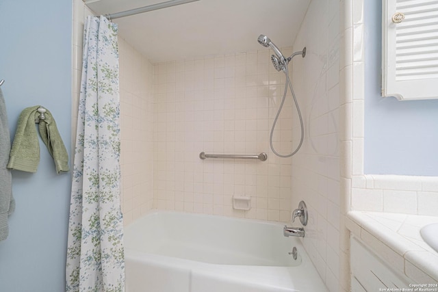 bathroom with shower / bath combo with shower curtain