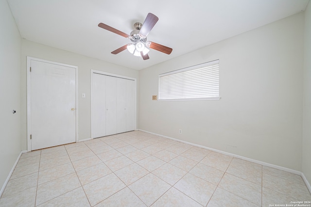 unfurnished bedroom with light tile patterned flooring and ceiling fan