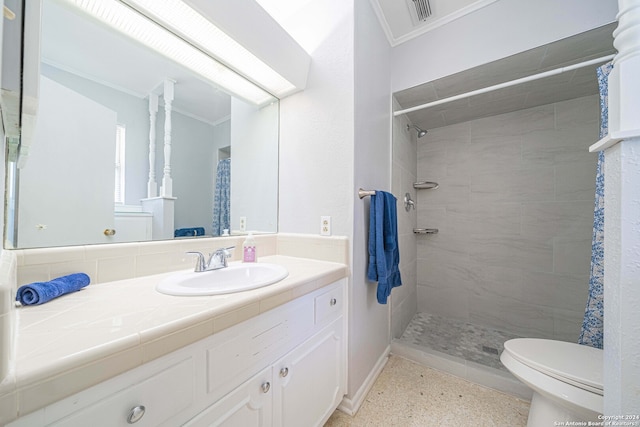 bathroom with a shower with curtain, toilet, vanity, and ornamental molding