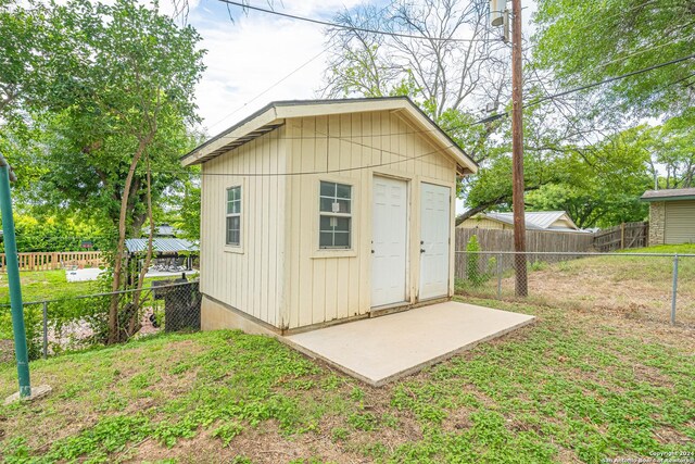 view of outbuilding with a lawn