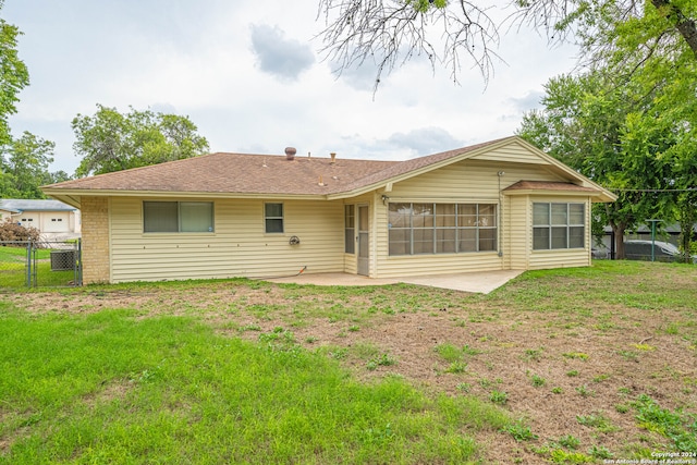 back of house featuring a patio area and a yard