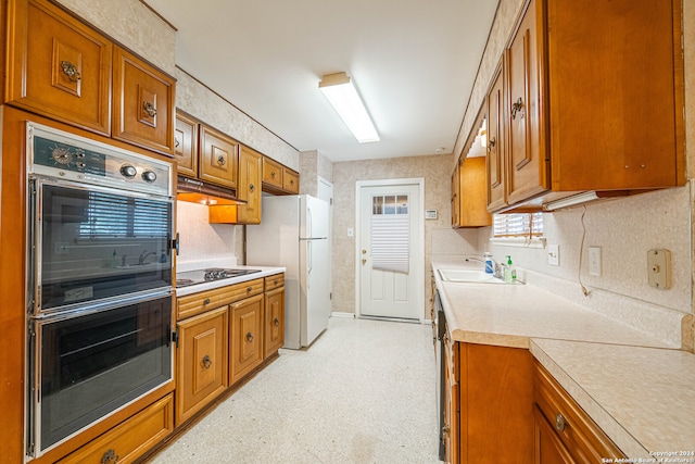 kitchen with premium range hood, white refrigerator, tasteful backsplash, stainless steel gas stovetop, and double oven