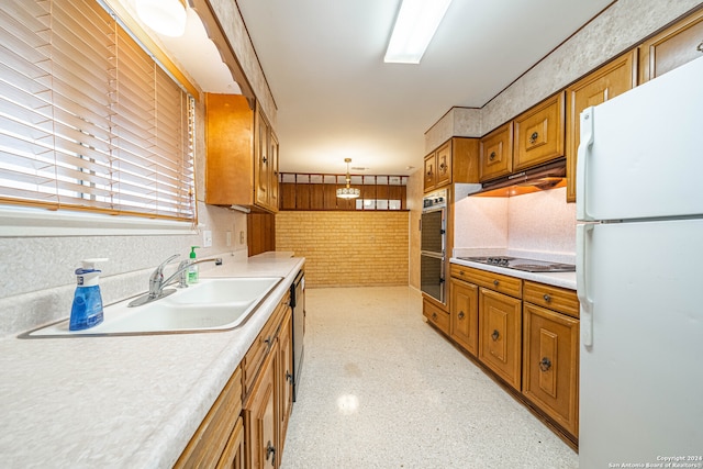 kitchen featuring appliances with stainless steel finishes, decorative light fixtures, and sink