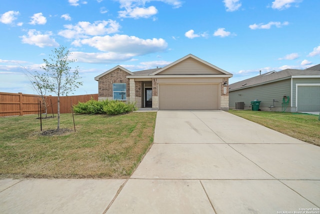 ranch-style house featuring a garage, central AC, and a front yard