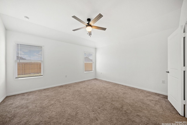 carpeted empty room featuring plenty of natural light and ceiling fan