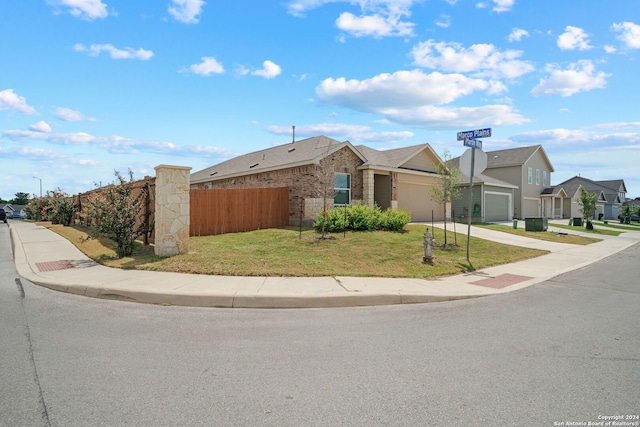 single story home with a garage and a front yard