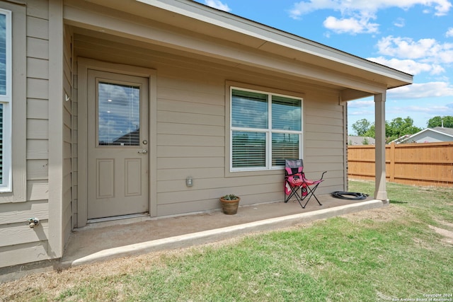 doorway to property featuring a yard