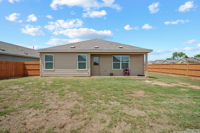 back of house with a yard