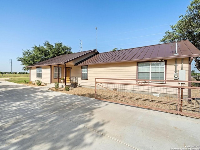 view of front facade featuring metal roof, crawl space, and a standing seam roof