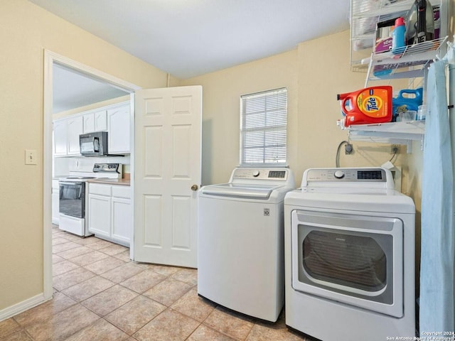washroom with laundry area, baseboards, washer and dryer, and light tile patterned flooring