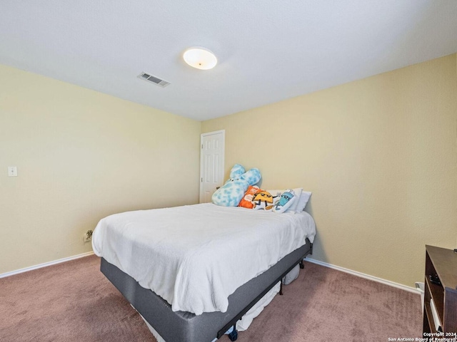 carpeted bedroom featuring visible vents and baseboards