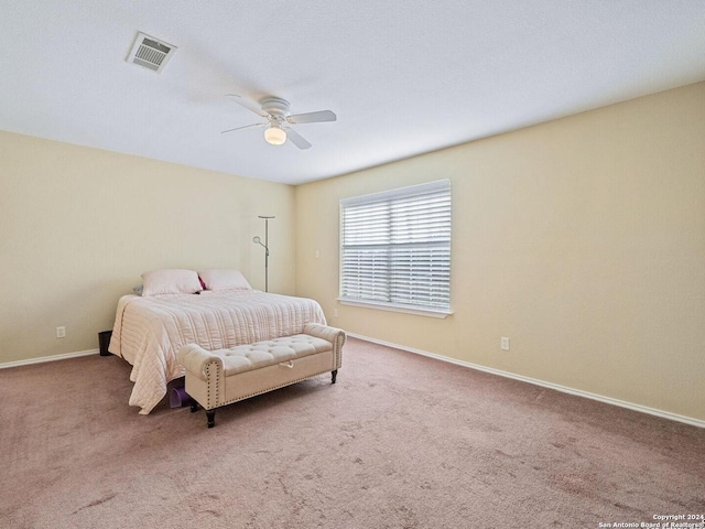 bedroom with carpet floors, baseboards, visible vents, and a ceiling fan