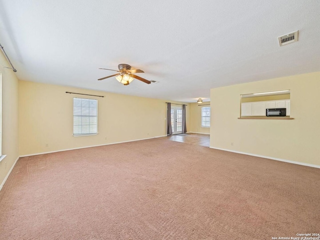 interior space featuring ceiling fan and plenty of natural light