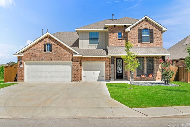 view of front of property with a garage and a front lawn