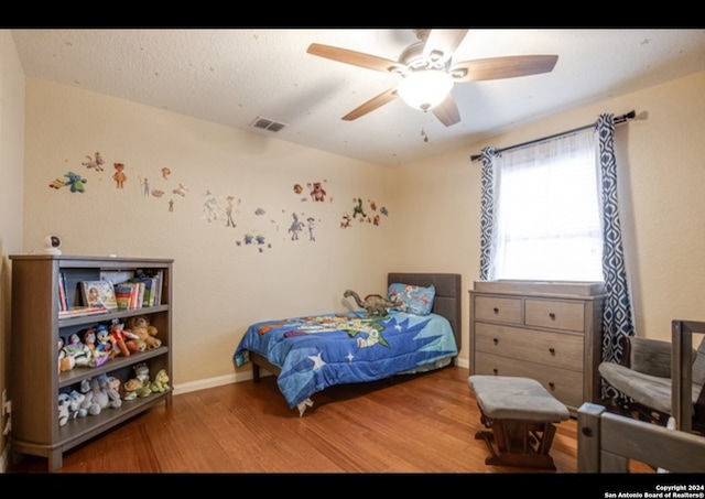 bedroom with wood-type flooring and ceiling fan