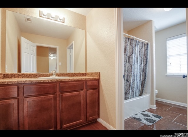 full bathroom featuring vanity, toilet, tile patterned floors, and shower / bath combination with curtain