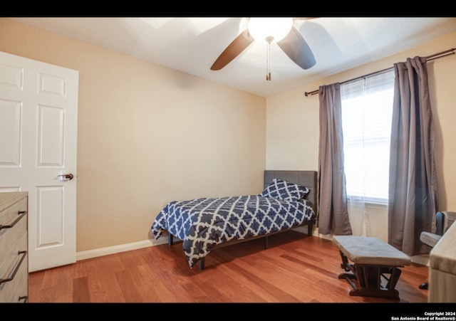 bedroom featuring ceiling fan and hardwood / wood-style flooring