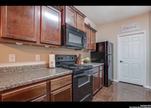 kitchen with black appliances and tile patterned flooring