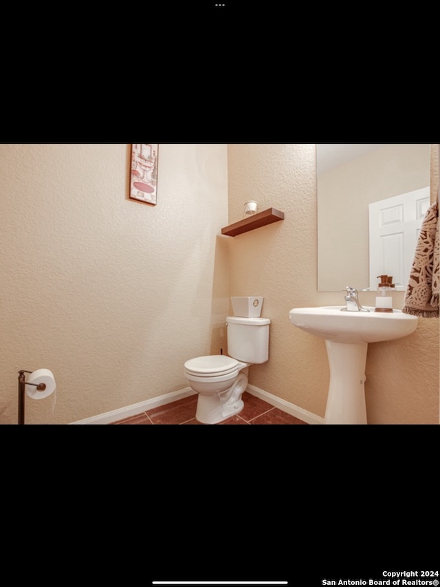 bathroom with tile patterned flooring and toilet