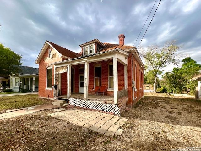 view of side of property with covered porch