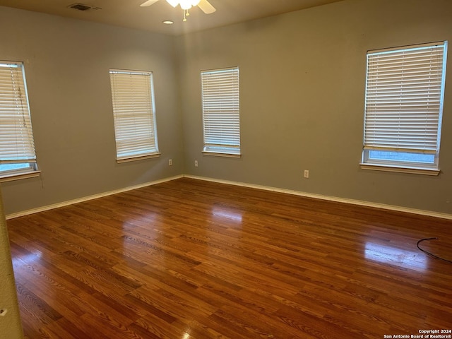 spare room featuring dark wood-type flooring and ceiling fan