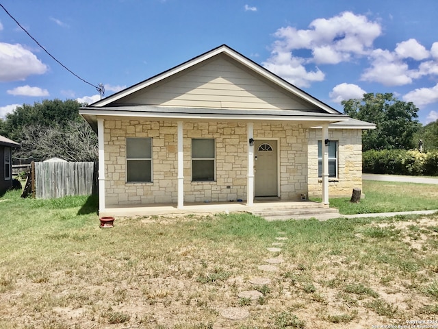 view of front of house with covered porch and a front yard