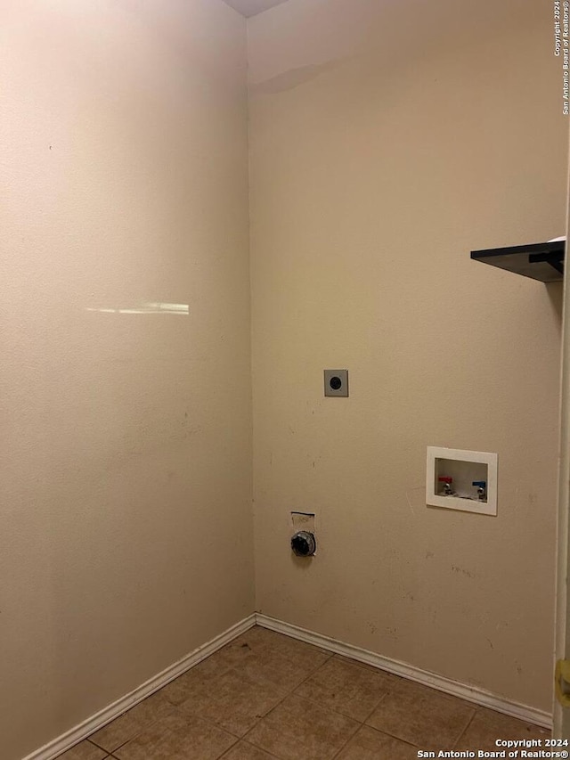 clothes washing area with hookup for a washing machine, electric dryer hookup, and light tile patterned floors