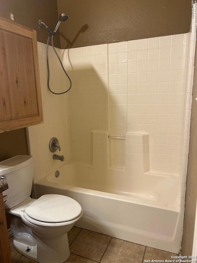 bathroom with tile patterned flooring, shower / bathtub combination, and toilet