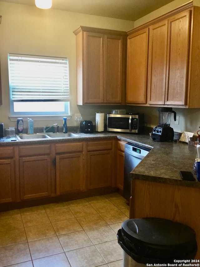 kitchen featuring light tile patterned floors, sink, and appliances with stainless steel finishes