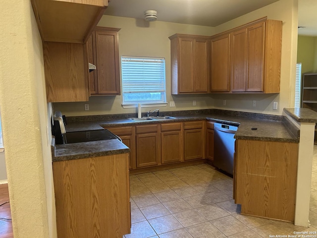 kitchen featuring sink, light tile patterned floors, dishwasher, stove, and kitchen peninsula