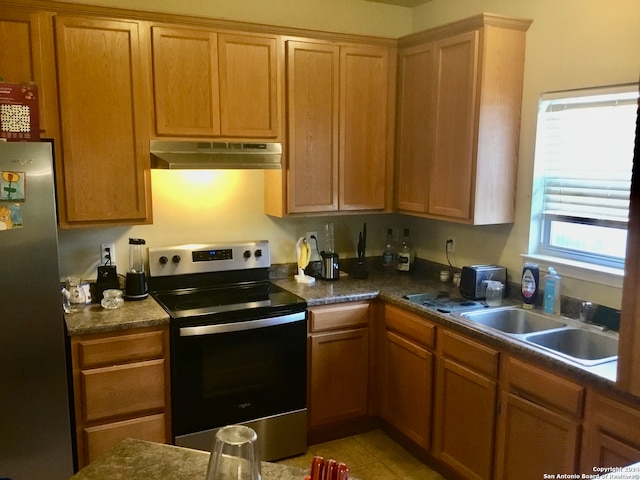 kitchen with sink, stainless steel appliances, and light tile patterned flooring