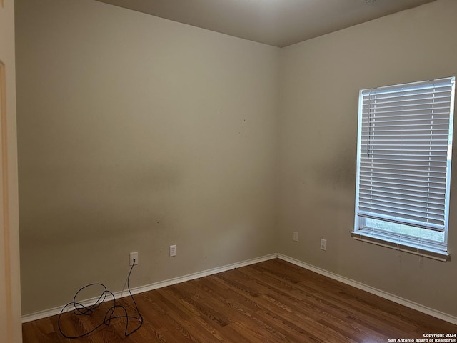 spare room featuring dark hardwood / wood-style flooring