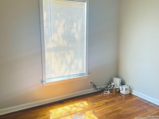 spare room with hardwood / wood-style flooring