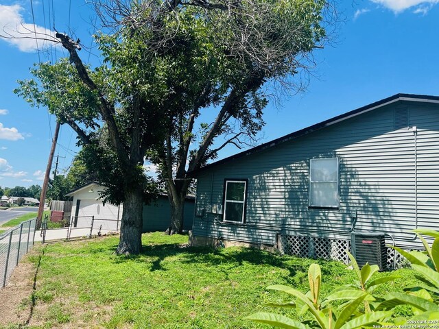 view of side of home featuring a yard