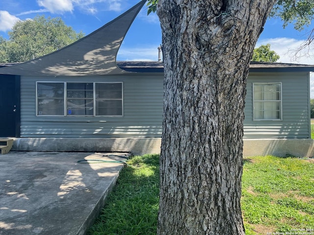 view of side of home featuring a patio area