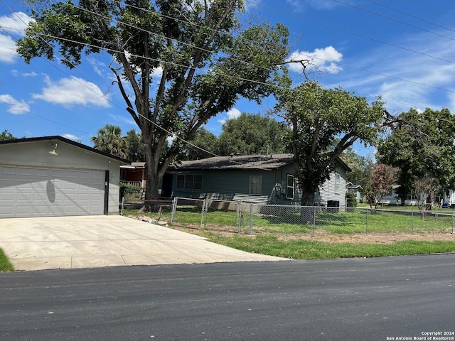 view of front of property with a garage and a front lawn