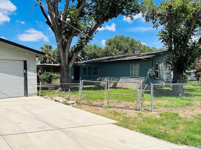 view of side of home featuring a garage and a yard