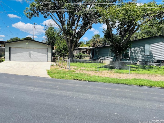 single story home with a garage, an outdoor structure, and a front lawn