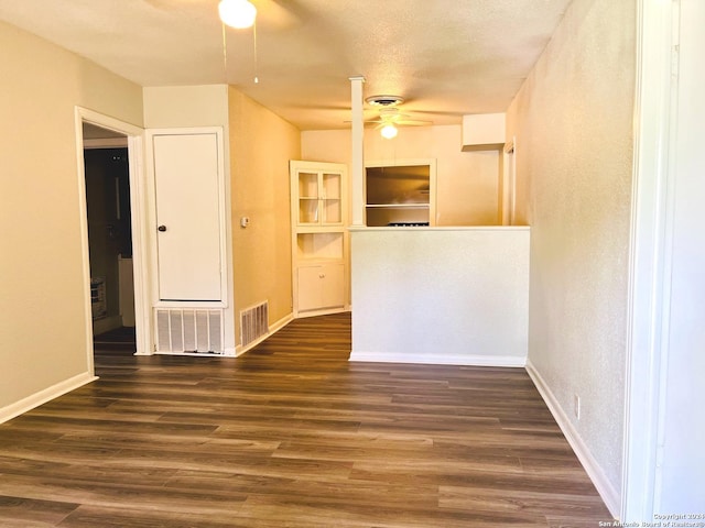 spare room with a textured ceiling, dark hardwood / wood-style floors, and ceiling fan