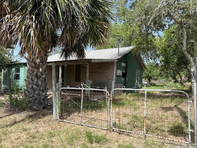 view of outdoor structure featuring a gate and fence