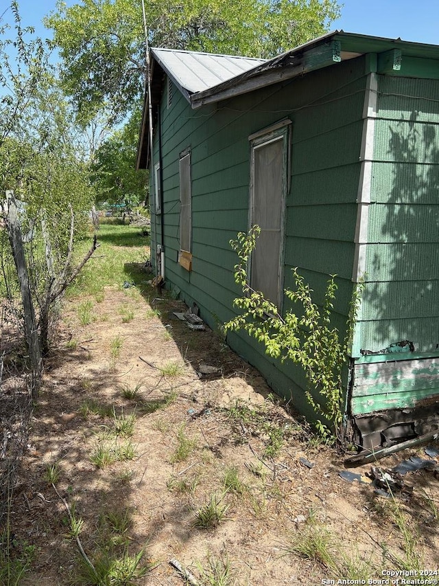 view of side of property featuring metal roof