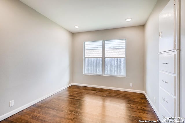 unfurnished room featuring dark hardwood / wood-style flooring