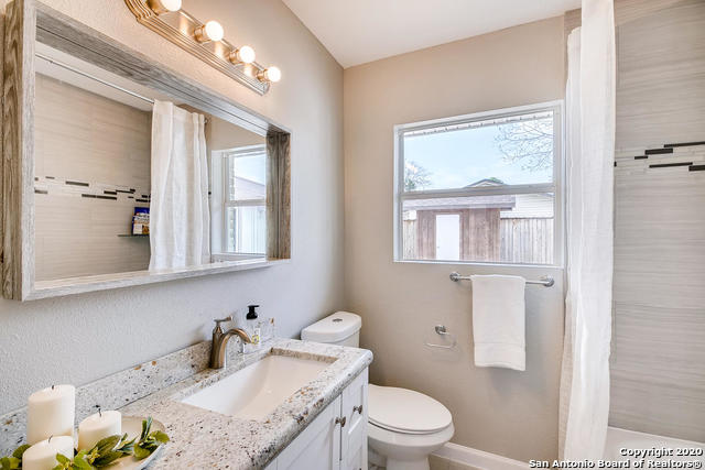 bathroom featuring vanity, toilet, and a wealth of natural light