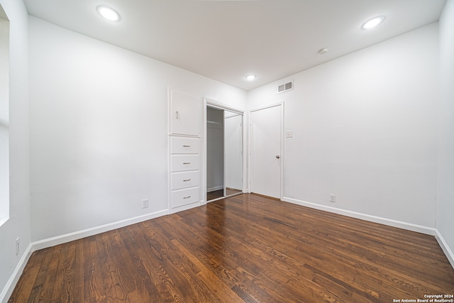 unfurnished bedroom with dark hardwood / wood-style flooring