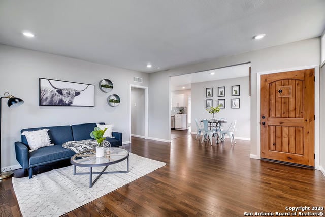 living room with dark hardwood / wood-style flooring